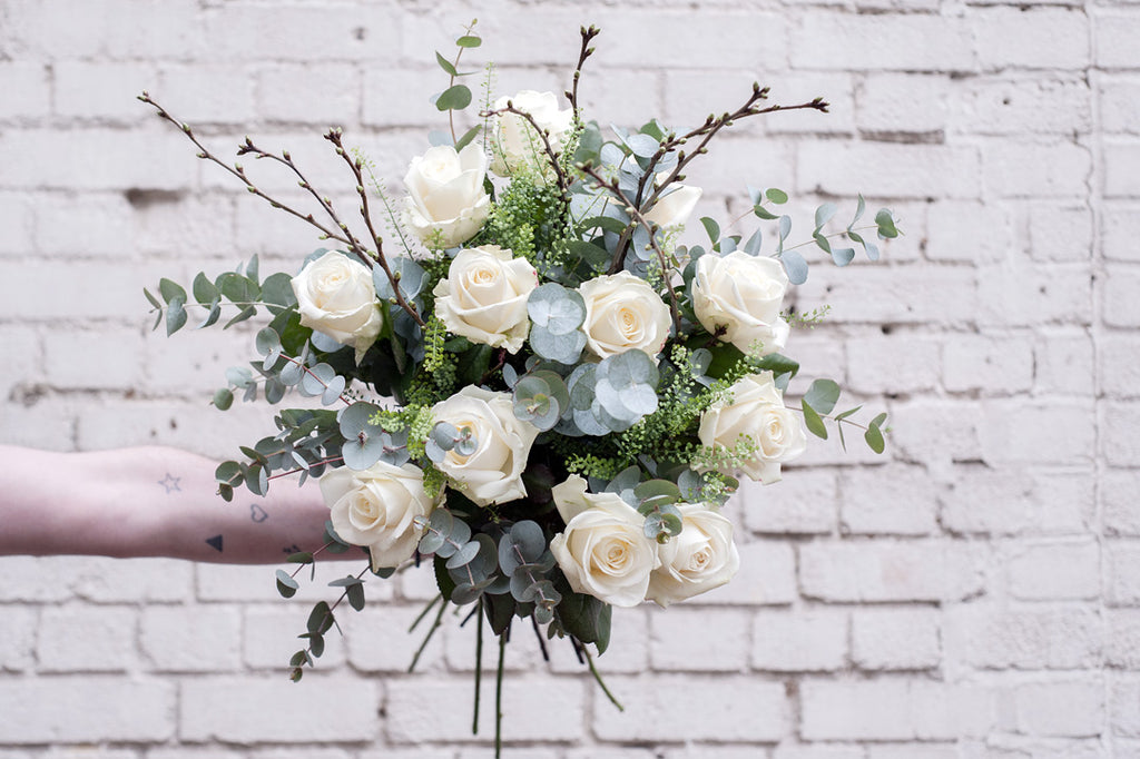 White roses mixed with green foliage